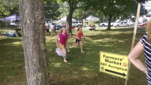 Children participate in the Union Farmers' Market's kids' scavenger hunt, a program that also operates out of the market information booth where SNAP customers pick up a shopping sheet and receive their Maine Harvest Bucks. 